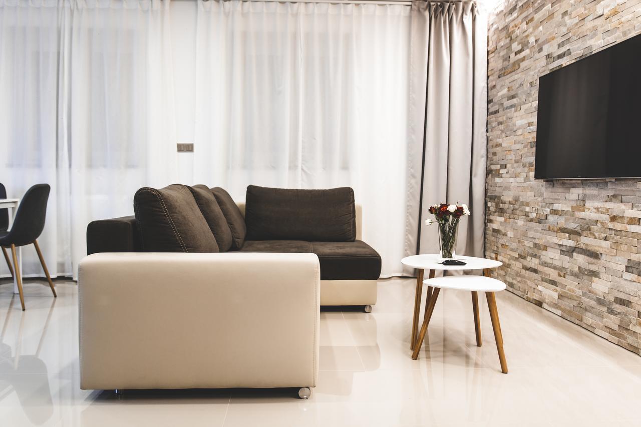 Silesia Residence Ostrava Kültér fotó A living room with a flat screen television